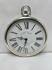 decorative wall clock designed to resemble a large pocket watch.