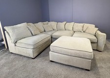 Large beige corner sofa with matching footstool