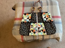 Shoulder bag hand sewn, zipper closer and wooden ring detail to handles