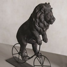 Lion Riding a Bicycle Figurine