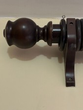 Dark brown wooden curtain pole, with finials