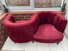 A reproduction kissing chair