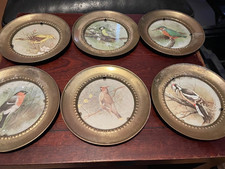 A set of six antique brass wall plates of various birds