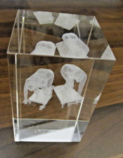 An Etched glass 3D hologram paperweight (swimmers)  3" high  -  boxed