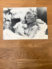 An original publicity print of Brigitte Bardot with her newborn baby, 14/1/1960.