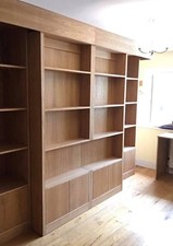 Sliding library, hidden bed