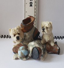 white westie statue figure chewing on boot