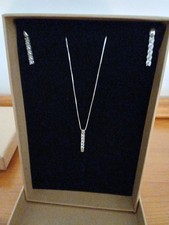 A Silver Necklace With A Cubic Zirconim  Pendant And Matching Earings