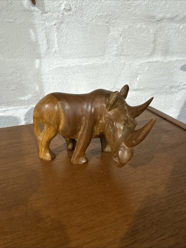 Hand carved teak rhino 9 - hand,