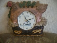 plastic chicken sitting on a basket wall clock