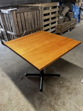 Square wooden table with sturdy metal leg
