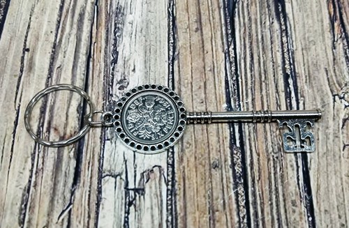 Sixpence mounted metal key - mounted,
