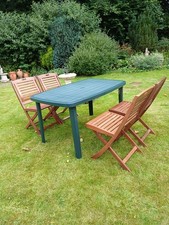Green garden table and 4 folding hard wood chairs, used/good condition