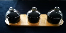 A SET OF BLACK CERAMIC FOOD POTS WITH GLASS COVERS ON BAMBOO TRAY - NEW