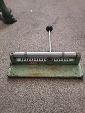 Rotaprint plate punch.