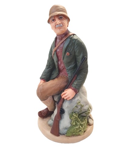 Vintage hunter figurine seated - hunter,