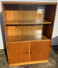 A Vintage Bookcase By B & S Goodman With Sliding Glass Doors Over A Cupboard