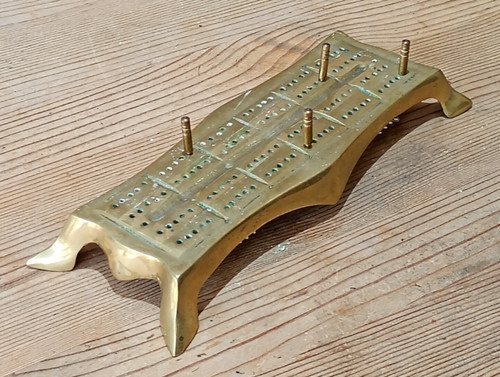 Brass cribbage board with - a,