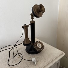 vintage-style candlestick telephone with a rotary dial.