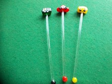 3 glass cocktail sticks with vehicles on top