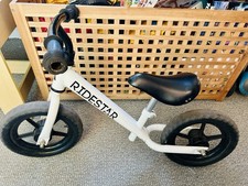 12” Balance push bike in great condition. White RideStar is perfect first bike 