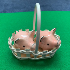 two  vintage  pink goebel  SALT AND PEPPER pigs in a basket .