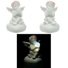 Sitting Cherub holding an LED