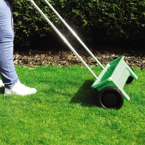 Garden spreader with drop - spreader,