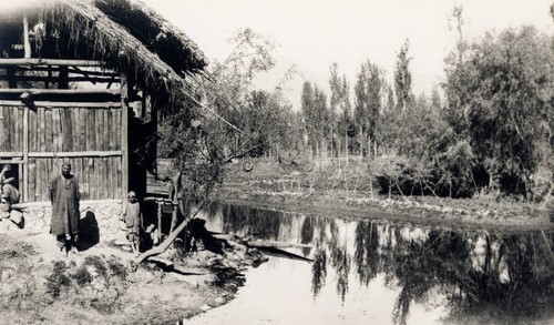 Men beside wooden huts the - men,