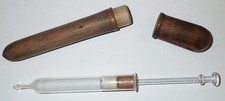 Antique glass enema syringe in wooden case/tube