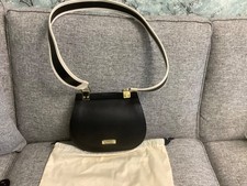 Modalu black leather saddle shoulder bag with black and cream strap