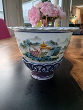 A famille-rose 'Mountain scene' bowl with rotating base