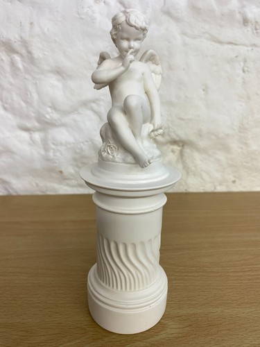 Alabaster cupid sitting a - cupid,