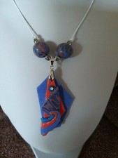 This gorges blue and orange abstract modern art necklace will enhance any outfit