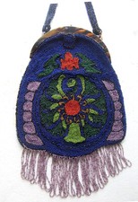 Heavily beaded purse early 20th century multi coloured floral motif with fringe.