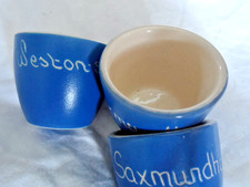Three Torquay ware egg cups blue and white