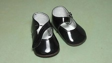 Pair of black doll shoes