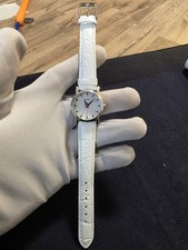 DKNY women's watch with a white mother-of-pearl dial and a white leather strap