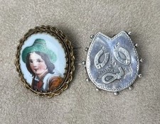 2 antique brooches, one hallmarked for silver with horseshoes and riding crop.