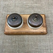 PAIR OF ANTIQUE DOLLY TOGGLE COPPER LIGHT SWITCHES MOUNTED ON WOODEN PATTRESS