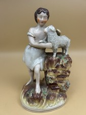 Staffordshire figure of a boy with the Lamb of God, 19thC, 7kin (19cm) high.