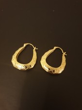 1 golden pair of hoop style earrings boxed in plastic stunning unused and unworn
