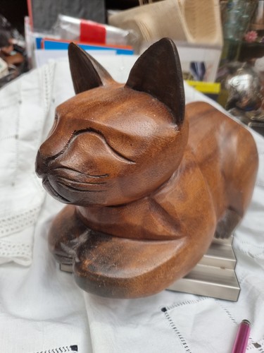 Hand carved wooden lying cat - hand,