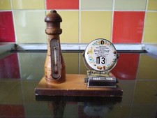 vintage chrome perpetual calendar on wooden light house base with thermometer