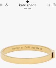 KATE SPADE GOLD IDIOM BANGLE ‘NEVER A DULL MOMENT’ ENGRAVED COSTUME JEWELLERY