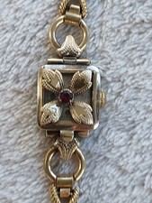 LADIES EXITA ART DECO WATCH ROLLED GOLD. FLORAL DESIGN COVER TO WATCH. WORKS.