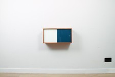 A vintage mid-century wall hung oak cabinet, blue & white sliding glass doors