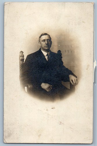 1911 man sitting unusual - sitting, on