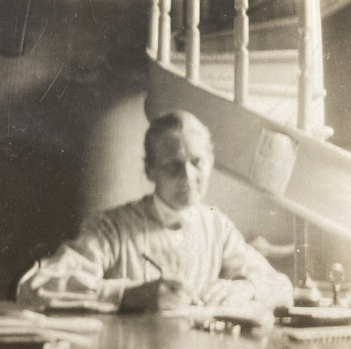 1925 older woman sitting desk - 1925,