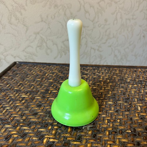 Vintage green metal hand bell - hand,